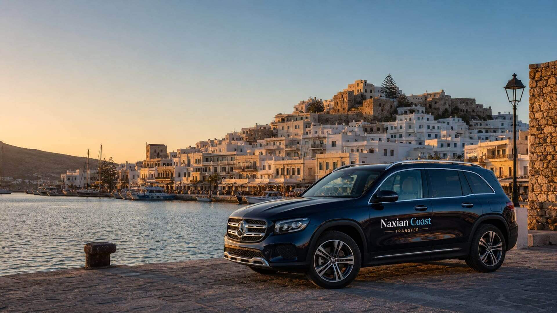 Naxian Coast Transfer vehicle by Naxos Chora harbor at golden hour