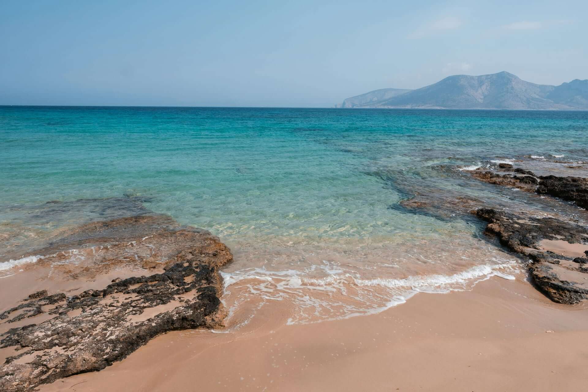Clear turquoise water and sandy beach in Naxos